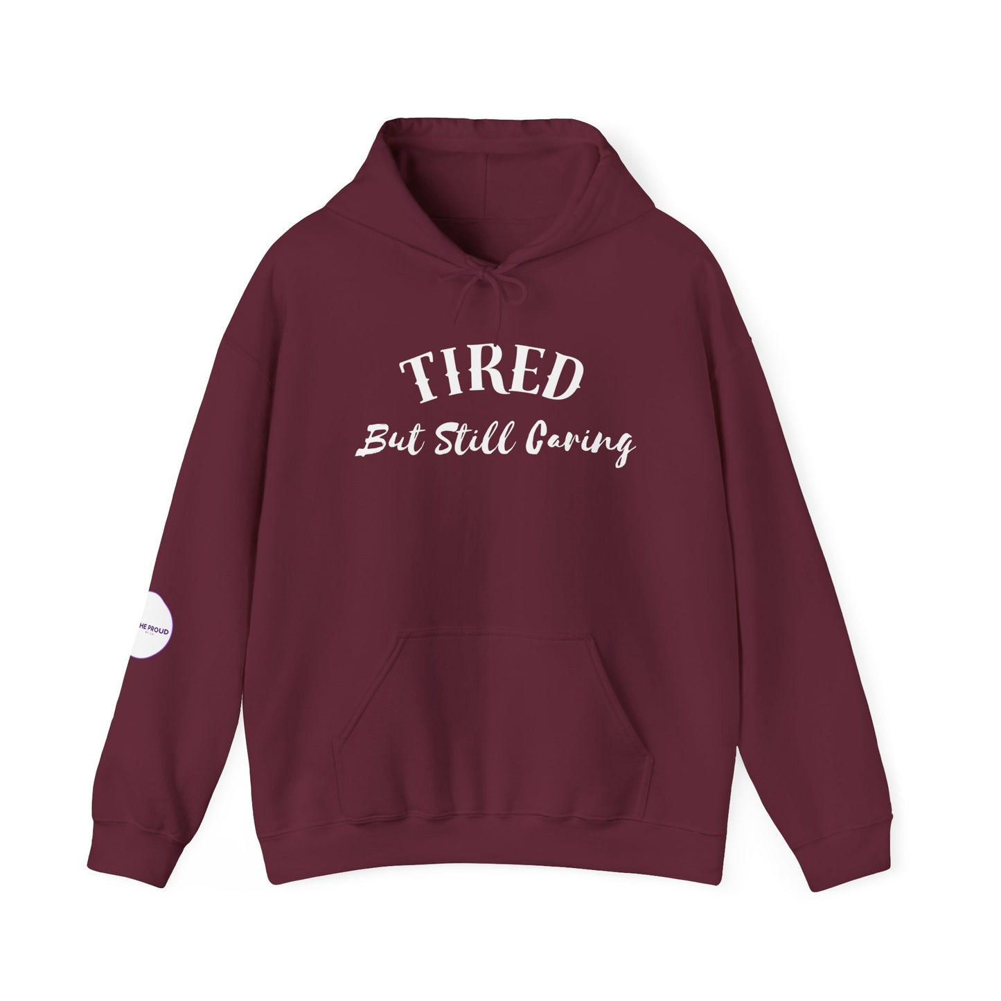 Tired But Still Caring Hoodie in burgundy with hand-lettered message on the front.