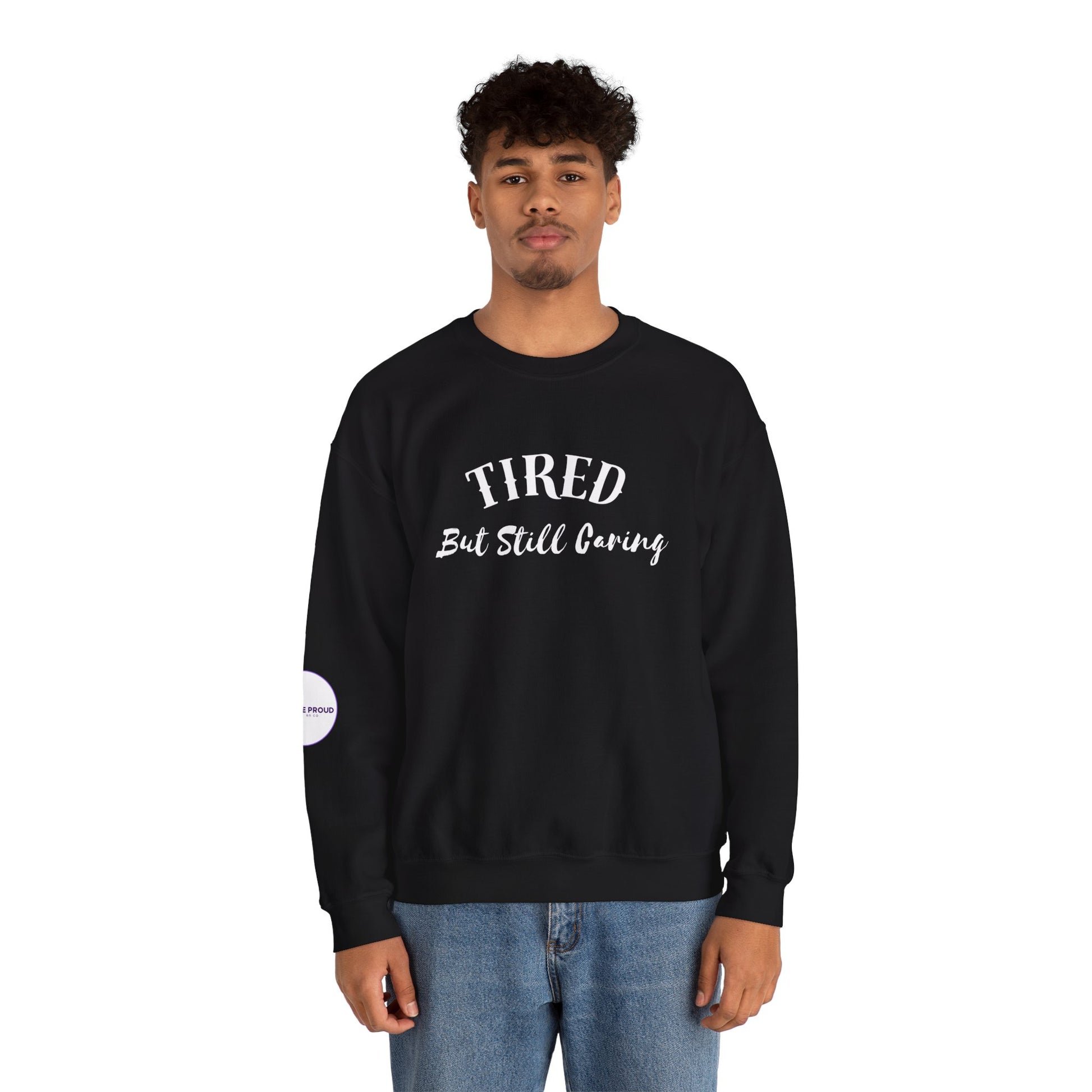 Front view of Tired But Still Caring Sweatshirt with simple type design
