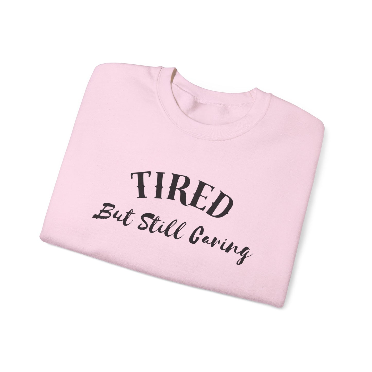 Front view of Tired But Still Caring Sweatshirt with simple type design