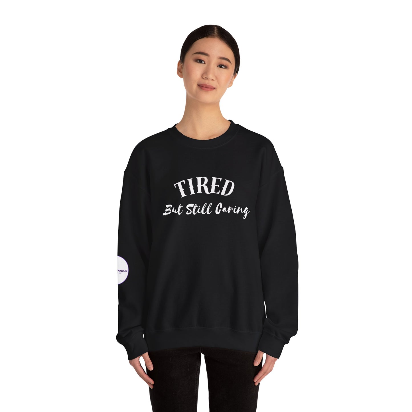 Front view of Tired But Still Caring Sweatshirt with simple type design