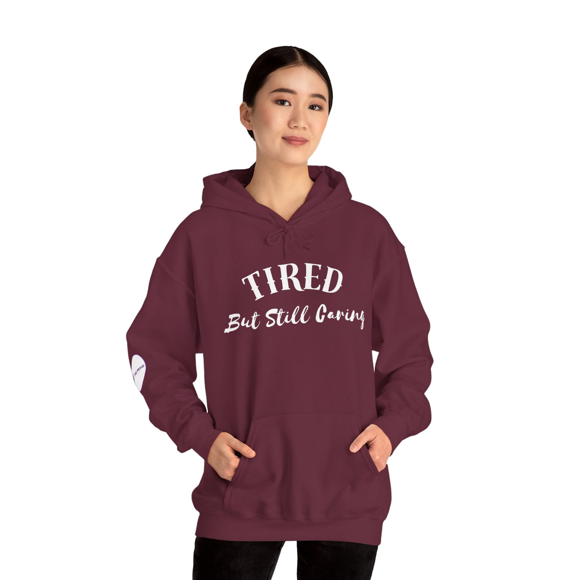 Tired But Still Caring Hoodie soft fleece sweatshirt with quote design