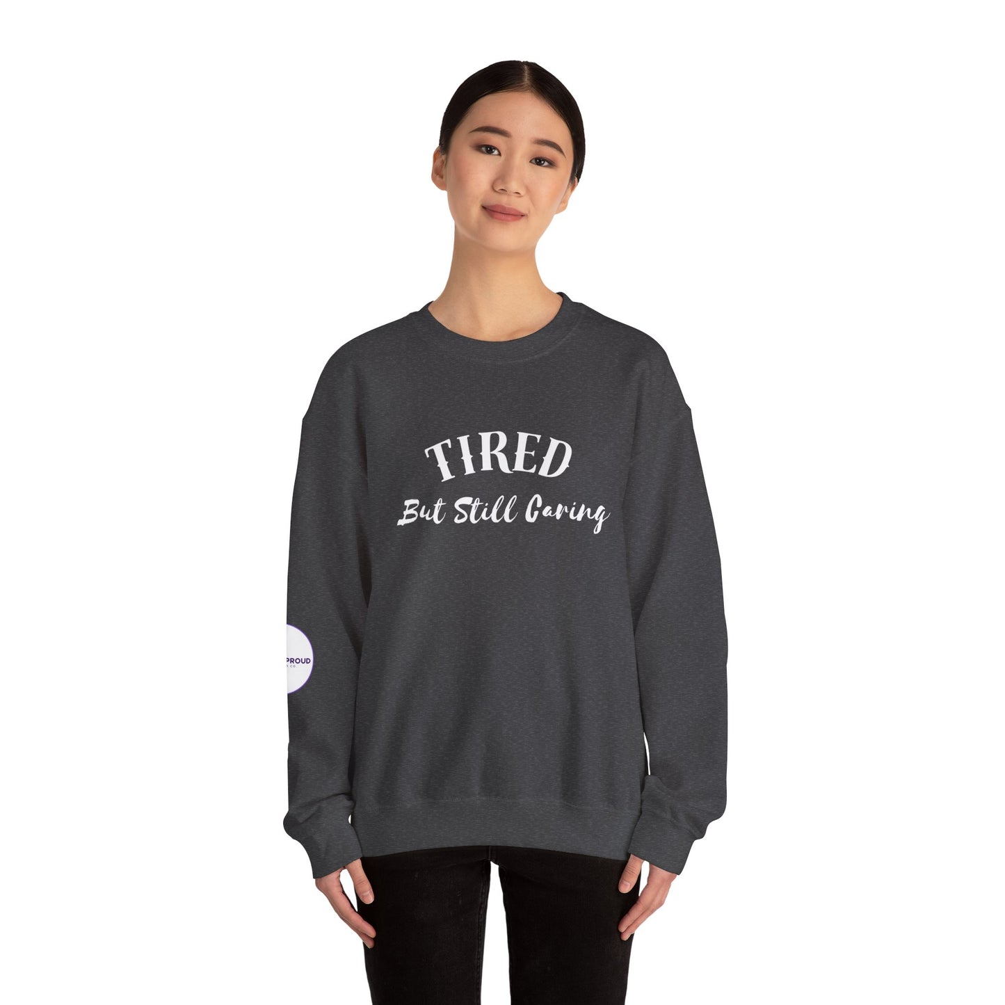 Front view of Tired But Still Caring Sweatshirt with simple type design