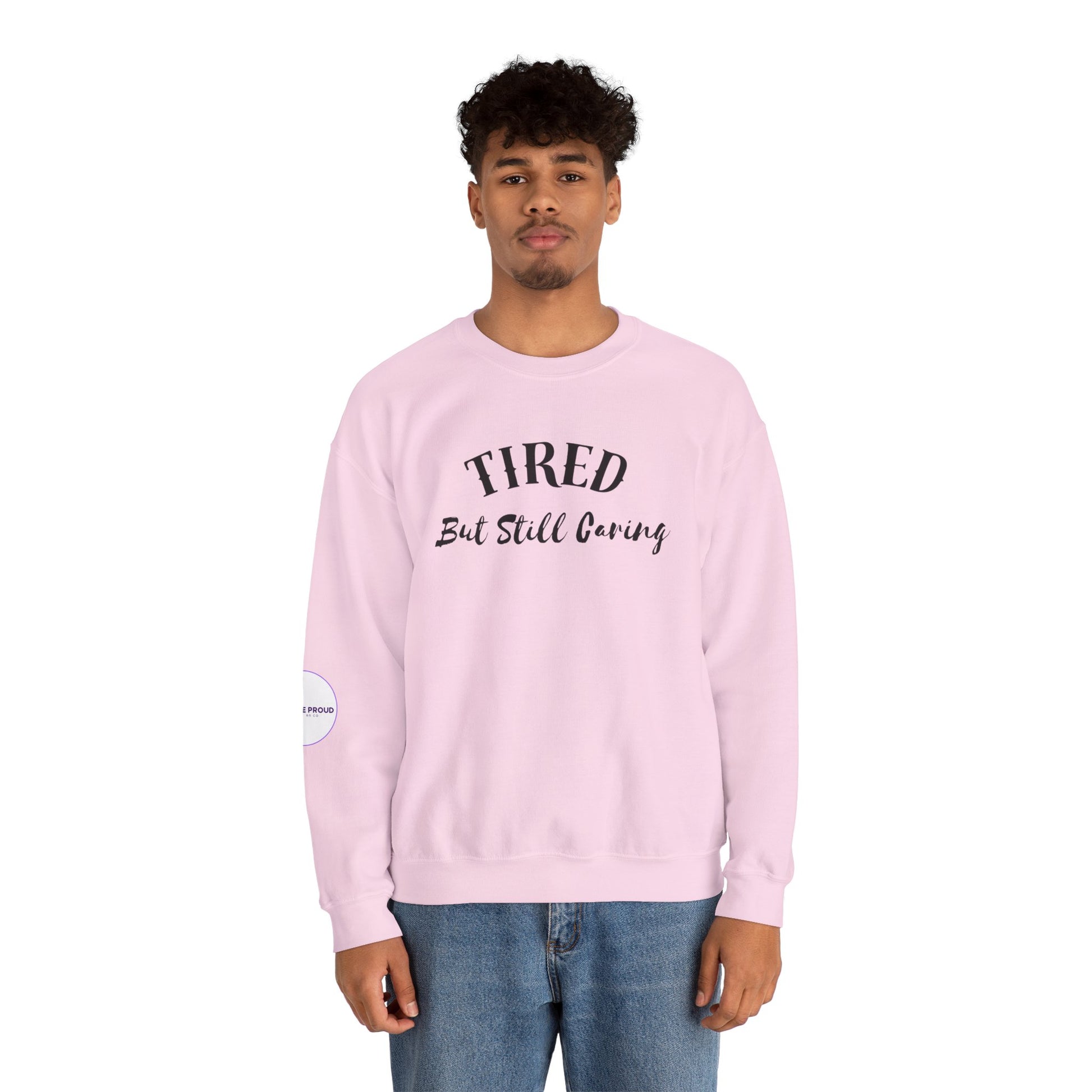 Front view of Tired But Still Caring Sweatshirt with simple type design