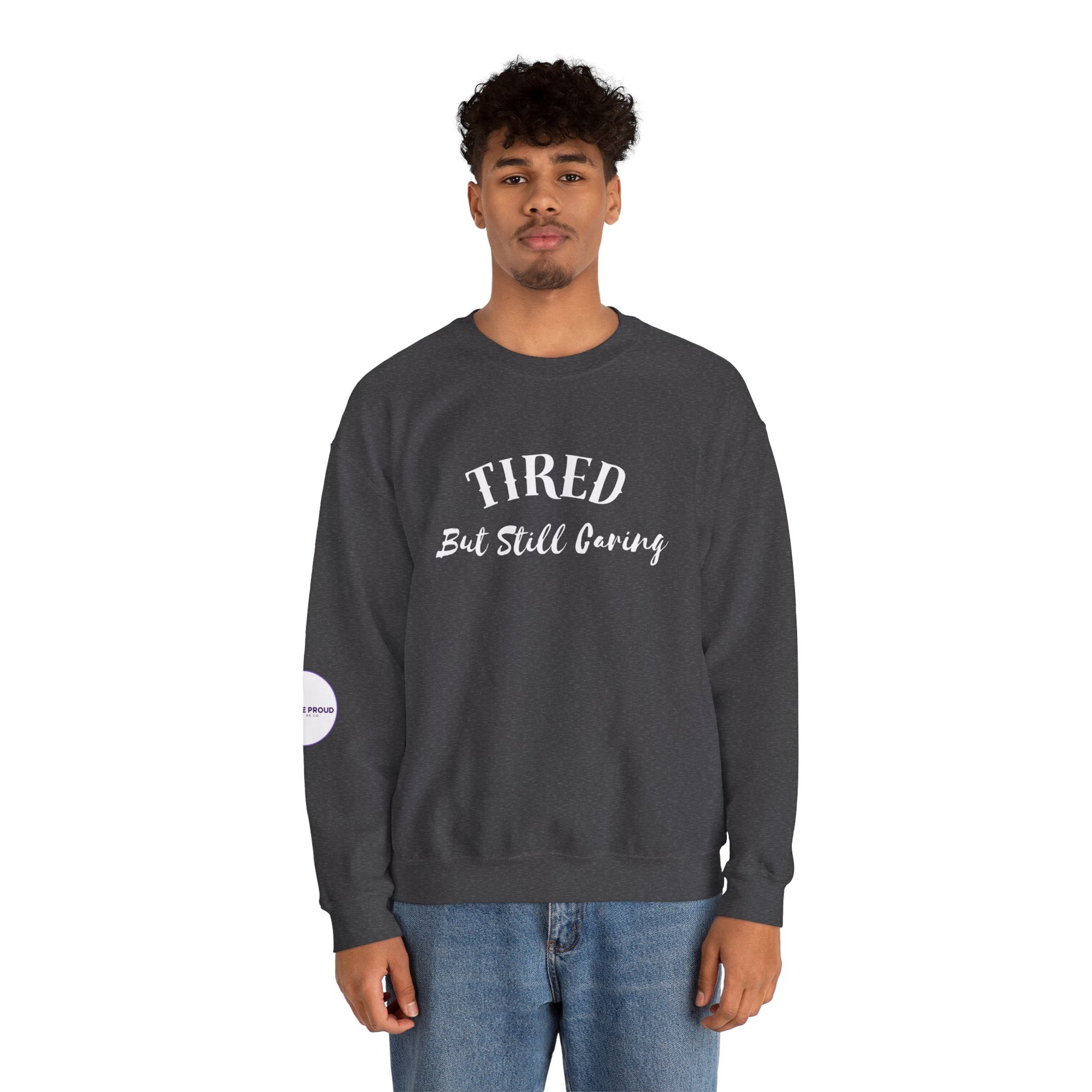 Front view of Tired But Still Caring Sweatshirt with simple type design